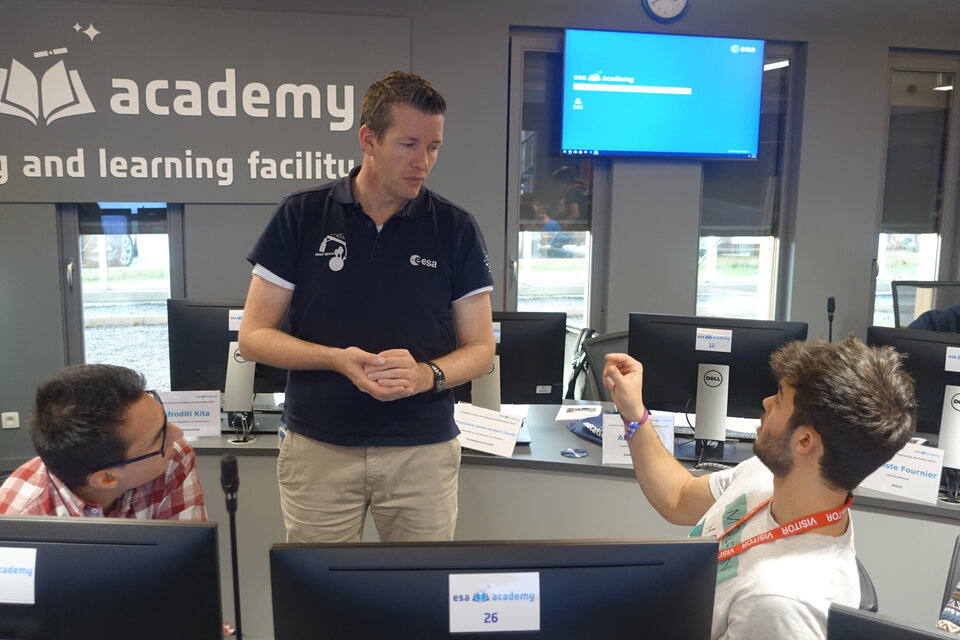 ESA expert discussing with the students during the CubeSat Concurrent Engineering Workshop 2019