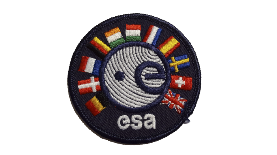Spot the difference: the first ESA agency patch featured 11 European flags and the original ESA logo.