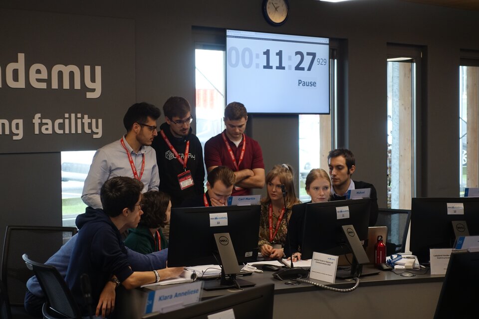 Time is running while the university students discuss possible causes and solutions for the communication problems of their spacecraft
