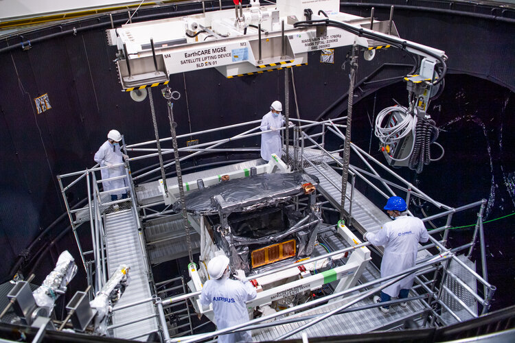 EarthCARE being lowered into the depths of the Large Space Simulator