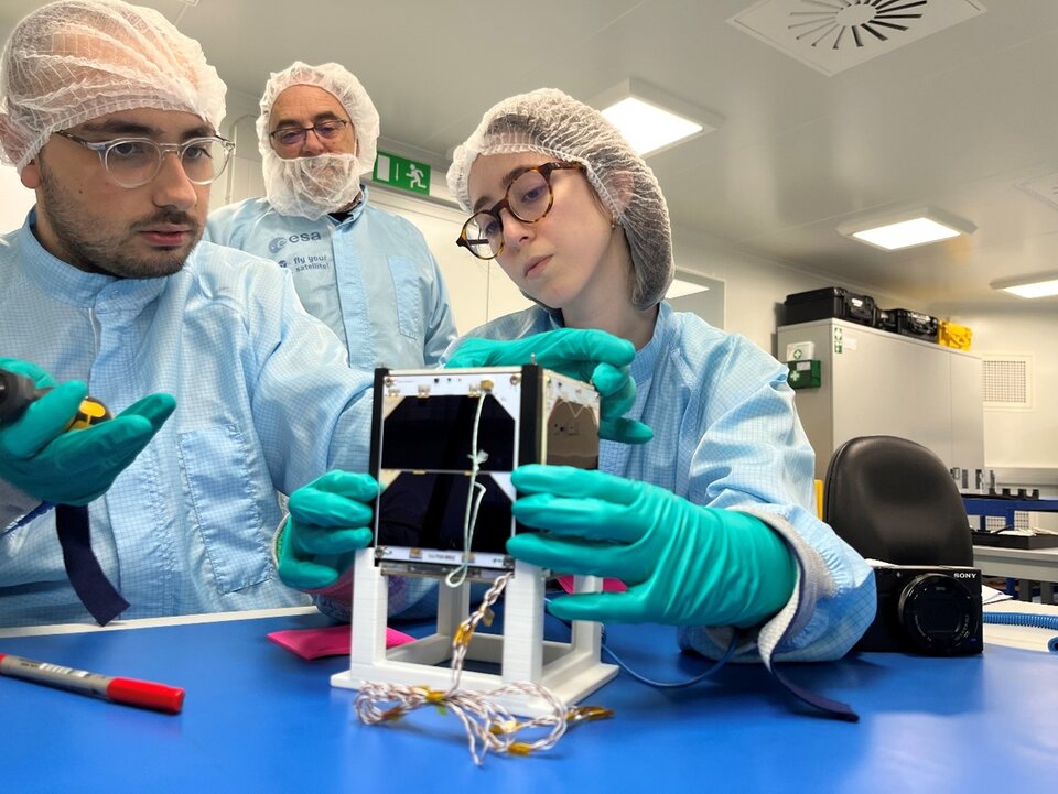 Students preparing the satellite for vibration test.