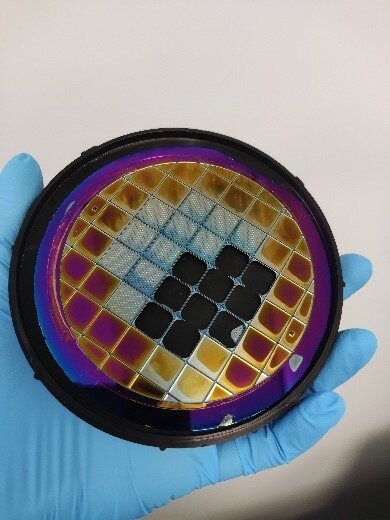Silicon wafer onto which emitters are microfabricated for mass production.