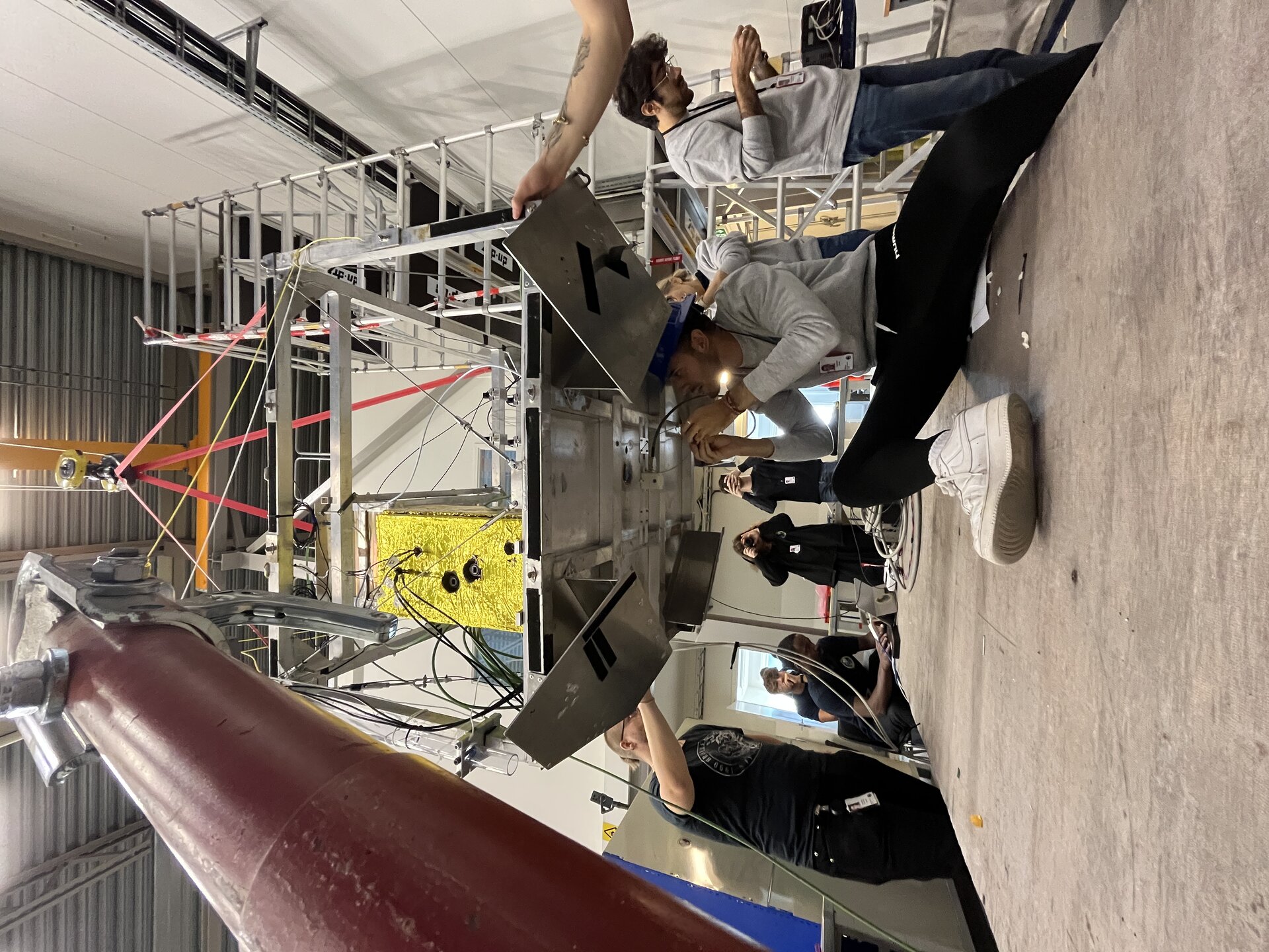 HERCCULES team installing a sensor of their experiment on the bottom of the gondola