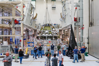 Crew module being stacked over the service module below it to form the Orion vehicle for Artemis II