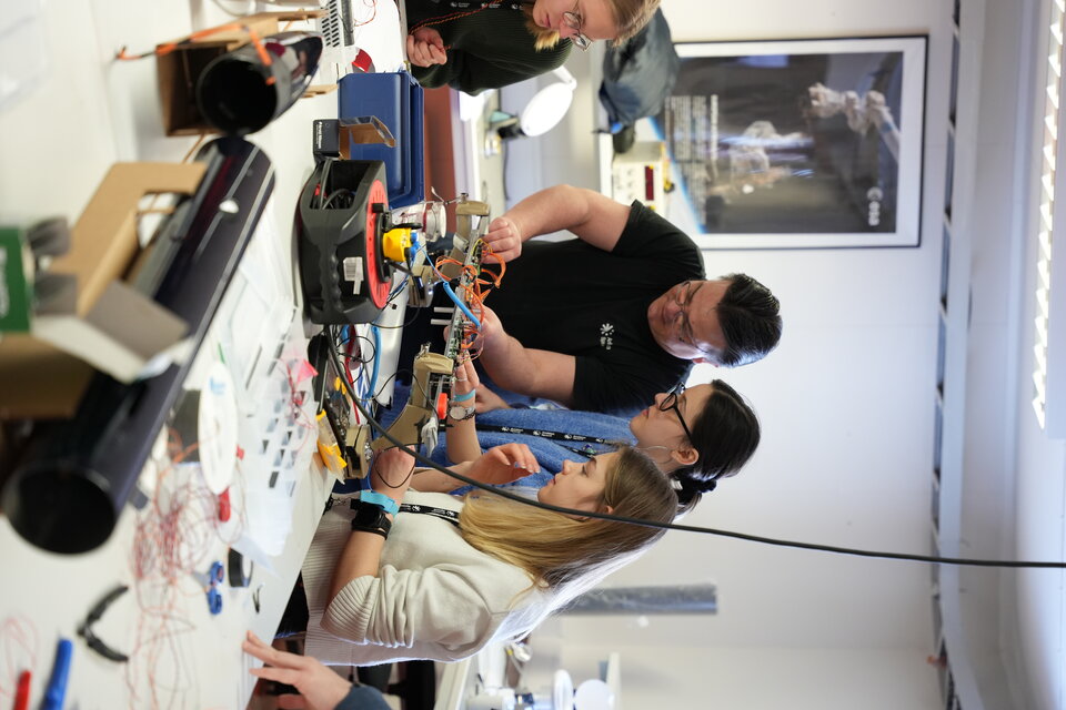 Students of the Payload section integrating sensors into the studrnt rockets payload adapter
