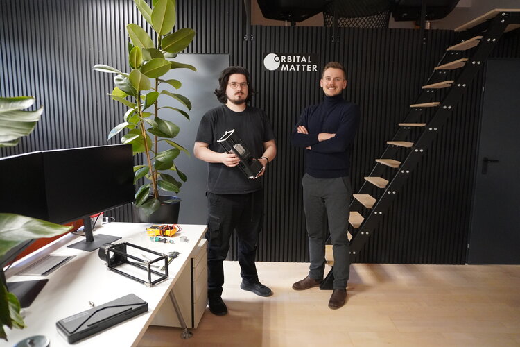 Jakub Stojek, CEO of Orbital Matter and Robert Ihnatisin, Chief Technology Officer, with a replica of their Replicator CubeSat at their office in Warsaw.