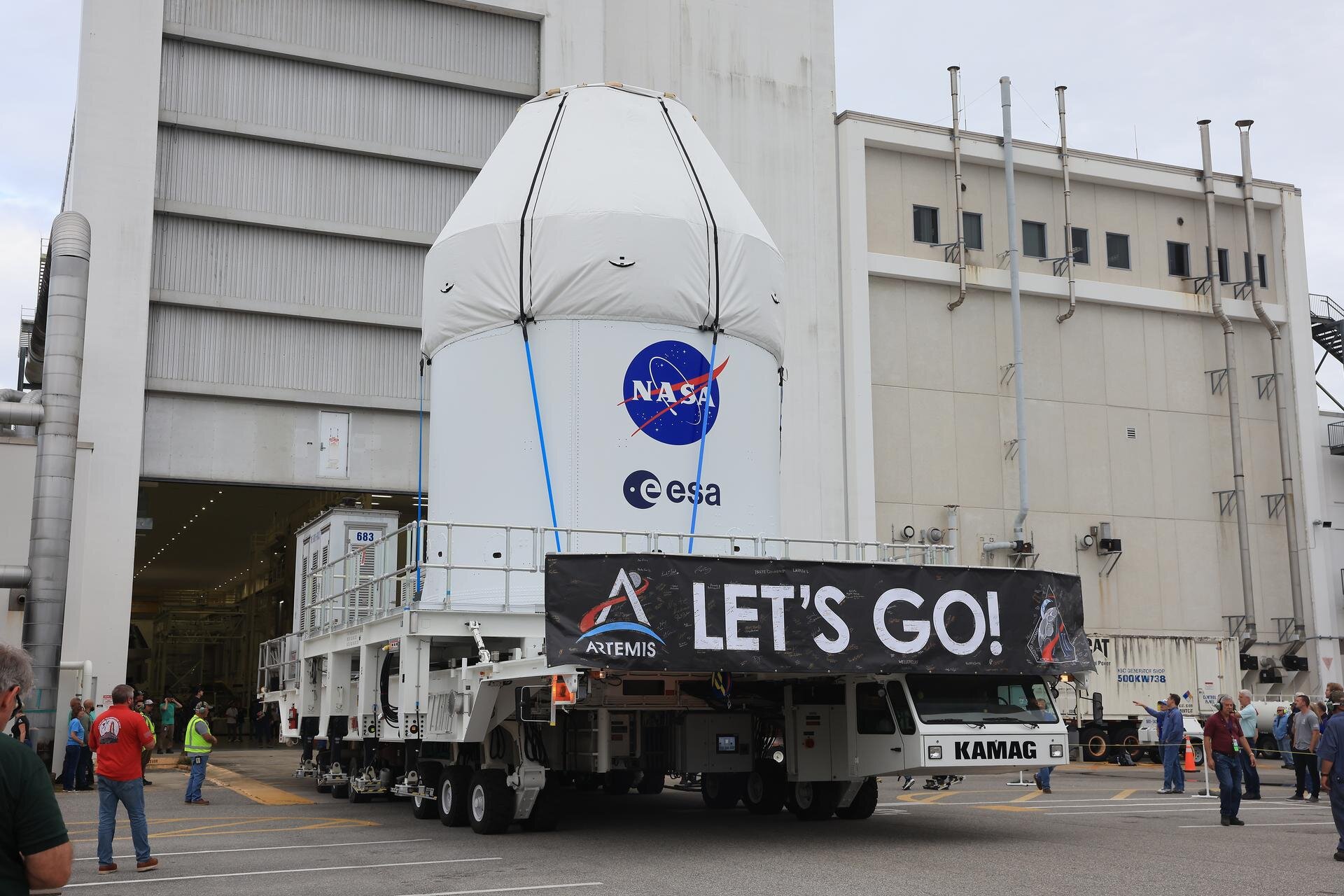 On 3 May, the fully assembled Orion spacecraft for Artemis II began its journey to the Multi-Payload Processing Facility at NASA’s Kennedy Space Center. The spacecraft is shown in transport, with its protective fairing panels clearly visible and proudly bearing the ESA and NASA logos. 