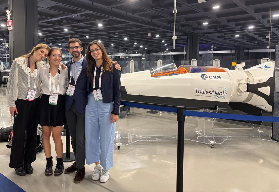 YPSat-2 members in front of Space Rider replica at the International Astronautical Congress 2024 in Milan